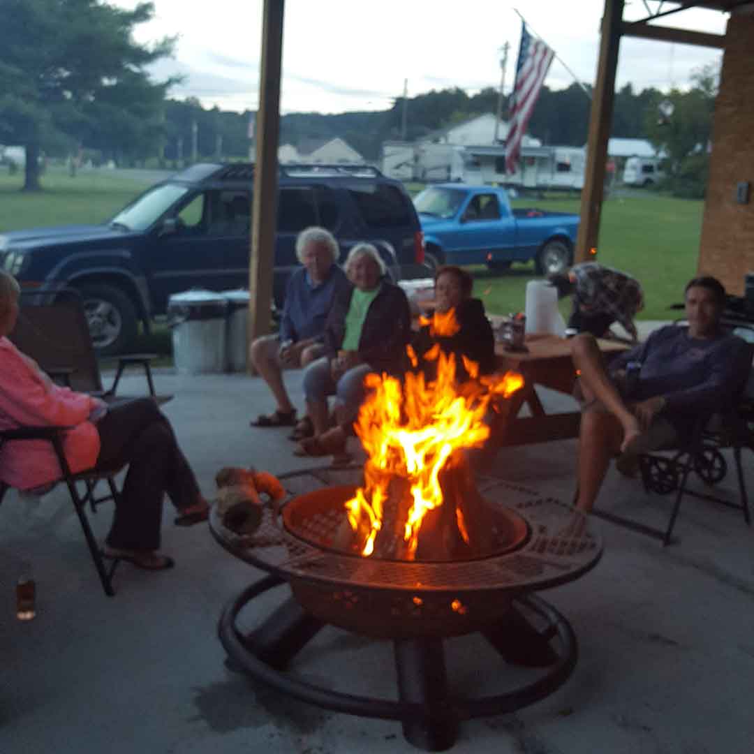 friends gather a the corn creek campfire for dinner